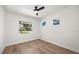 Bright bedroom features new hardwood floors, updated window, and a ceiling fan at 2089 Sunderland Rd, Maitland, FL 32751