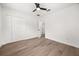 Unfurnished bedroom featuring wood flooring, ceiling fan and closet space at 2089 Sunderland Rd, Maitland, FL 32751