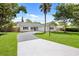 Charming single story home with a winding driveway, lawn, mature trees, and updated paint at 2089 Sunderland Rd, Maitland, FL 32751