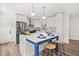 Open kitchen with island, seating, and stainless steel appliances perfect for gatherings at 2089 Sunderland Rd, Maitland, FL 32751