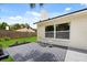 A paved patio with seating sits near the side of this lovely home and green backyard at 2089 Sunderland Rd, Maitland, FL 32751