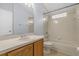 Well-lit bathroom featuring a single sink vanity and a shower-tub combo with glass block window at 2181 Jessa Dr, Kissimmee, FL 34743