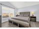 Cozy bedroom with gray floors, a queen-sized bed, and a window overlooking the yard at 2181 Jessa Dr, Kissimmee, FL 34743