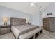 Bedroom with gray floors, queen size bed, two side tables and chest of drawers at 2181 Jessa Dr, Kissimmee, FL 34743