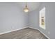 Bright, airy room with wood floors, a modern chandelier, and a view of the front yard at 2181 Jessa Dr, Kissimmee, FL 34743