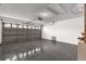 Spacious garage with gray epoxy flooring and white brick walls at 2181 Jessa Dr, Kissimmee, FL 34743
