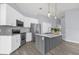 Modern kitchen featuring stainless steel appliances, white cabinets, and a gray island at 2181 Jessa Dr, Kissimmee, FL 34743