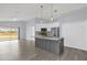 Open kitchen with gray island and white cabinets flows into a bright living area at 2181 Jessa Dr, Kissimmee, FL 34743