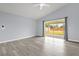Bright living room with gray floors and sliding glass doors to the backyard at 2181 Jessa Dr, Kissimmee, FL 34743