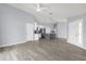 Open floor plan with gray floors and bright lighting leading to the kitchen at 2181 Jessa Dr, Kissimmee, FL 34743