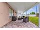 Covered patio featuring stone floors and a cozy seating area, perfect for outdoor relaxation at 2181 Jessa Dr, Kissimmee, FL 34743