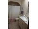 Well-lit bathroom featuring a vanity with marble countertop, updated fixtures, and a shower-tub combo at 2320 Ne 43Rd St, Ocala, FL 34479