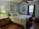 Comfortable bedroom with hardwood floors, soft lighting and a ceiling fan at 2320 Ne 43Rd St, Ocala, FL 34479