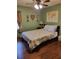 Cozy bedroom offering hardwood floors and natural light from a bright window at 2320 Ne 43Rd St, Ocala, FL 34479