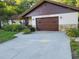 Charming home featuring a well-maintained front yard with a stone facade and attached garage at 2320 Ne 43Rd St, Ocala, FL 34479