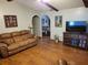 Inviting living area with hardwood flooring, comfortable seating, and seamless flow to the dining room at 2320 Ne 43Rd St, Ocala, FL 34479