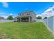 Picture of a spacious green backyard with a white fence and a large two-story house at 2560 Hayden Valley Street, Apopka, FL 32703