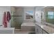 A beautifully tiled bathroom with a walk-in shower, soaking tub, and granite countertops at 2560 Hayden Valley Street, Apopka, FL 32703