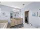 A bright primary bathroom with a soaking tub, dual sinks, and a granite countertop at 2560 Hayden Valley Street, Apopka, FL 32703