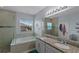 A spacious bathroom featuring a soaking tub, a walk-in shower, and dual sinks with granite countertops at 2560 Hayden Valley Street, Apopka, FL 32703