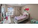A cheerful bedroom with a white bed frame and colorful unicorn wall decor at 2560 Hayden Valley Street, Apopka, FL 32703