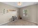 A cozy bedroom decorated with a nature-themed wall and a built-in bookshelf at 2560 Hayden Valley Street, Apopka, FL 32703