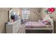A charming bedroom with a white bed, dresser, and cute decorative accents at 2560 Hayden Valley Street, Apopka, FL 32703
