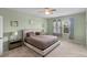 Bright bedroom featuring a ceiling fan, plush carpet, and a large window with patterned curtains at 2560 Hayden Valley Street, Apopka, FL 32703