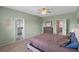 A bedroom featuring plush carpet and doorway views to the bathroom and hallway at 2560 Hayden Valley Street, Apopka, FL 32703