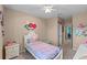 A cozy bedroom decorated with unicorn wall decor and a comfortable bed at 2560 Hayden Valley Street, Apopka, FL 32703