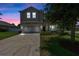 Charming two-story home featuring a well-manicured lawn, driveway, and attached two-car garage at 2560 Hayden Valley Street, Apopka, FL 32703