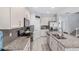 Well-lit kitchen showcasing granite countertops, stainless steel appliances, and stylish gray backsplash at 2560 Hayden Valley Street, Apopka, FL 32703
