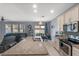 Open kitchen featuring granite countertops, stainless steel appliances, island with sink and an adjacent dining area at 2560 Hayden Valley Street, Apopka, FL 32703