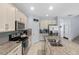 Bright kitchen featuring granite countertops, stainless steel appliances, and ample cabinet space at 2560 Hayden Valley Street, Apopka, FL 32703