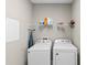 A convenient laundry room with washer, dryer, and shelf space at 2560 Hayden Valley Street, Apopka, FL 32703