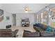 The open-concept living room features neutral walls, modern furniture, large windows and tile floors at 2560 Hayden Valley Street, Apopka, FL 32703