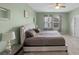 Spacious main bedroom boasts a modern bed, neutral walls, plush carpet and lots of natural light at 2560 Hayden Valley Street, Apopka, FL 32703
