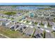 An aerial view captures the expanse of the neighborhood with lake views and a community pool at 313 Sofia Ln, Lake Alfred, FL 33850