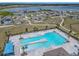 Aerial view of community pool complex, showing ample seating and lake views in the distance at 313 Sofia Ln, Lake Alfred, FL 33850