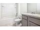 Bathroom with combination tub and shower, toilet, and sink with vanity at 313 Sofia Ln, Lake Alfred, FL 33850