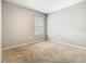 Bedroom with neutral walls, carpet, and a window at 313 Sofia Ln, Lake Alfred, FL 33850