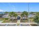 Community clubhouse with palm trees in front, tables with umbrellas, and gated pool area at 313 Sofia Ln, Lake Alfred, FL 33850