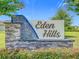 Eden Hills community sign with stone and blue mosaic accents and beautiful landscaping at 313 Sofia Ln, Lake Alfred, FL 33850