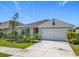 Charming one-story home with landscaped front yard and a two-car garage on a sunny day at 313 Sofia Ln, Lake Alfred, FL 33850