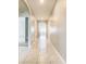 Bright hallway with tiled floors and arched doorways creating an open and inviting atmosphere at 313 Sofia Ln, Lake Alfred, FL 33850