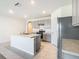 Open concept kitchen with stainless steel appliances, an island, and tile flooring offering space and style at 313 Sofia Ln, Lake Alfred, FL 33850