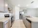 Well-equipped kitchen with stainless steel appliances, gray cabinetry, and a functional center island at 313 Sofia Ln, Lake Alfred, FL 33850