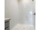 Walk-in shower with white tiled walls and shower head at 313 Sofia Ln, Lake Alfred, FL 33850
