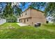 Spacious backyard featuring a well-maintained lawn, concrete patio, and mature trees at 3322 Park Branch Ave, Clermont, FL 34711