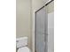 Modern bathroom featuring sliding glass shower doors with white tiles and a standard toilet at 3322 Park Branch Ave, Clermont, FL 34711